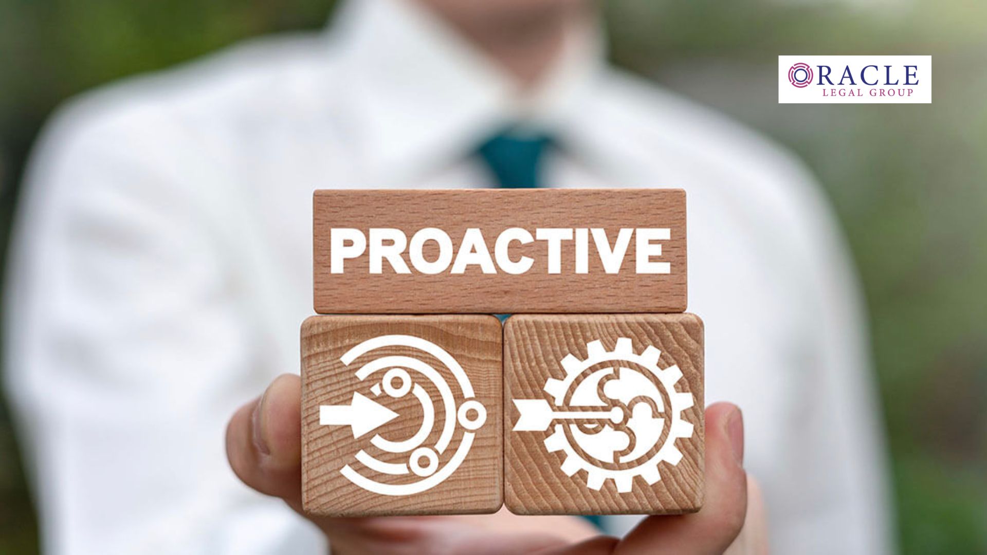 Close-up of a person holding wooden blocks with the word “PROACTIVE” and icons representing strategy and systems; Oracle Legal Group logo in the corner, symbolizing forward-thinking legal and business solutions