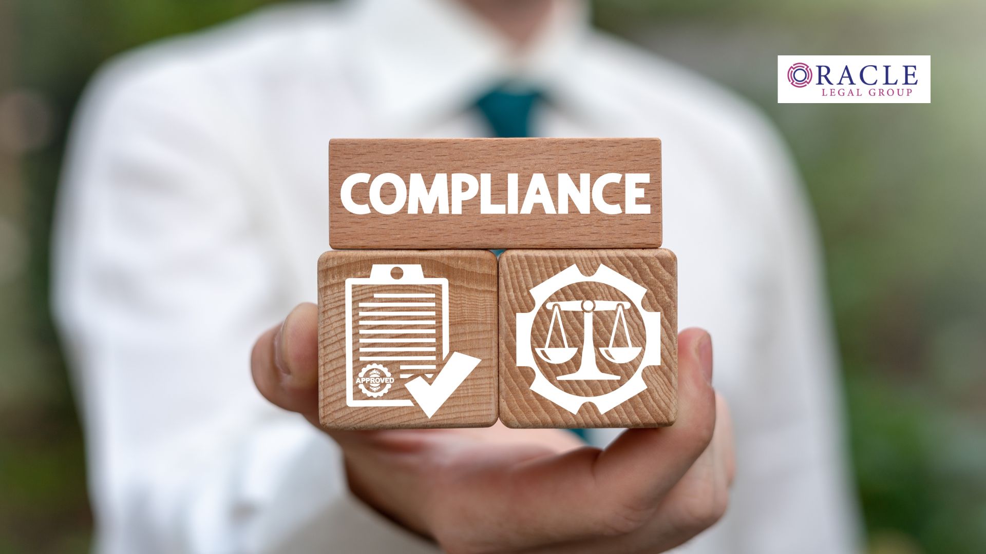 Close-up of a person in business attire holding wooden blocks with icons representing compliance, licensing, and legal enforcement; Oracle Legal Group logo in the corner